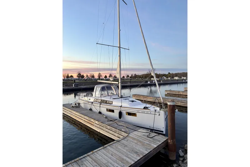  Yacht Photos Pics 2019 Beneteau Oceanis 35.1 sailboat docked at sunset in a serene marina.