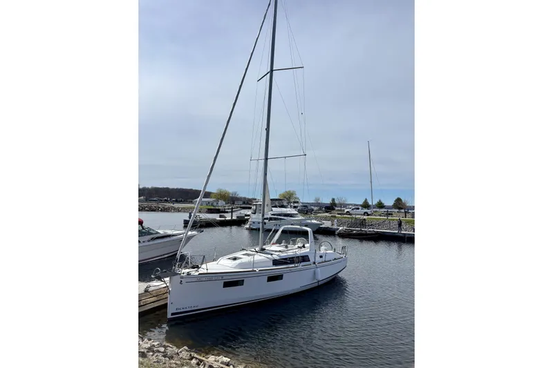  Yacht Photos Pics 2019 Beneteau Oceanis 35.1 sailboat docked in a marina under a clear sky.
