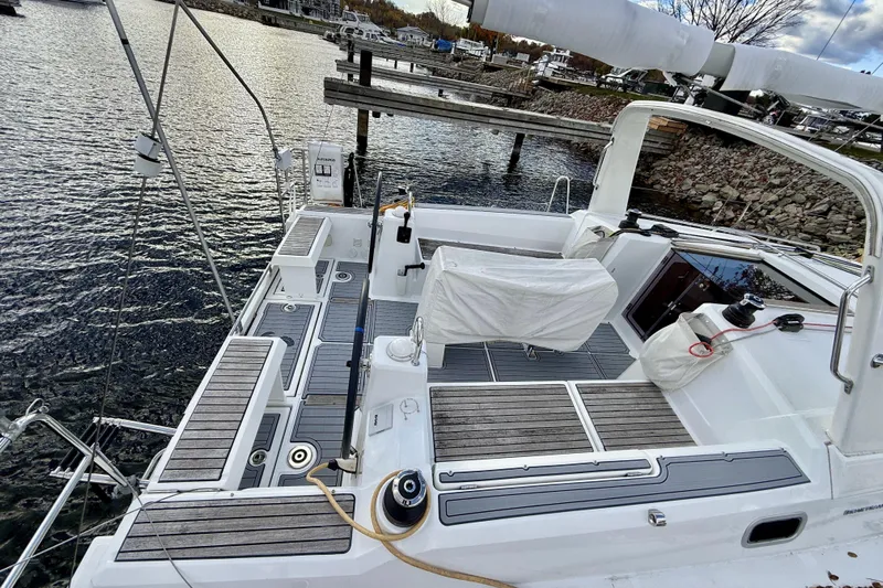  Yacht Photos Pics 2019 Beneteau Oceanis 35.1 sailboat cockpit with covered seating, docked by the water.