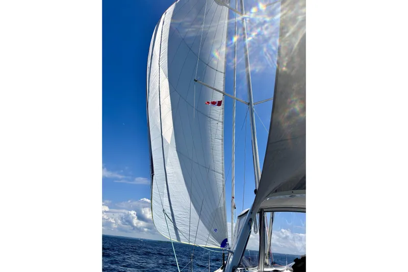  Yacht Photos Pics 2019 Beneteau Oceanis 35.1 sailing with full sails under a clear blue sky.