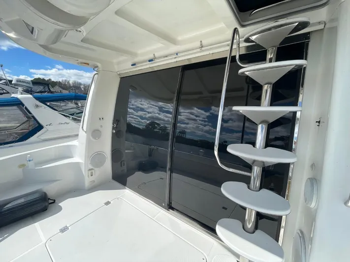 Relentless Yacht Photos Pics 1998 Carver 530 Voyager Pilothouse yacht interior with spiral staircase and sliding glass doors.