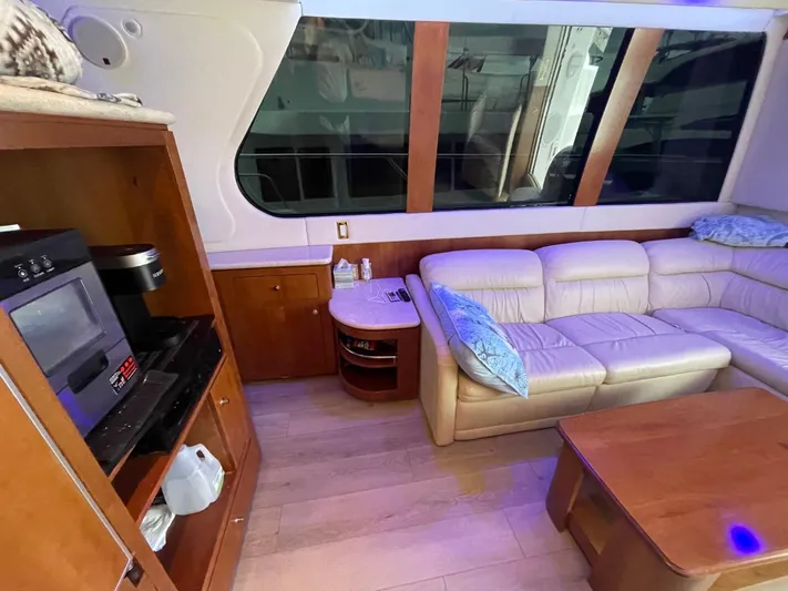 Relentless Yacht Photos Pics Interior of 1998 Carver 530 Voyager Pilothouse with leather seating and wooden cabinetry.