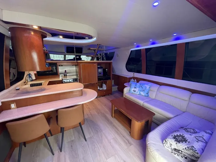 Relentless Yacht Photos Pics Luxurious interior of 1998 Carver 530 Voyager Pilothouse with modern seating and kitchen area.