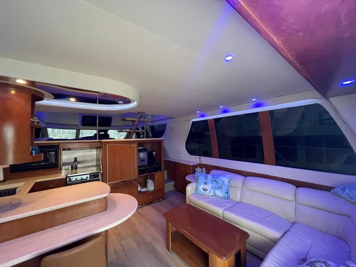 Relentless Yacht Photos Pics Luxurious interior of 1998 Carver 530 Voyager Pilothouse with modern furnishings and ambient lighting.