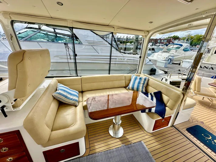 Southern Cross Yacht Photos Pics Luxurious 2017 MJM 50z yacht interior with beige seating and wooden table.