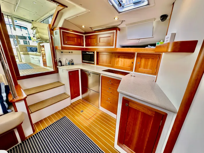 Southern Cross Yacht Photos Pics Luxurious 2017 MJM 50z yacht interior with elegant wood cabinetry and modern kitchen amenities.