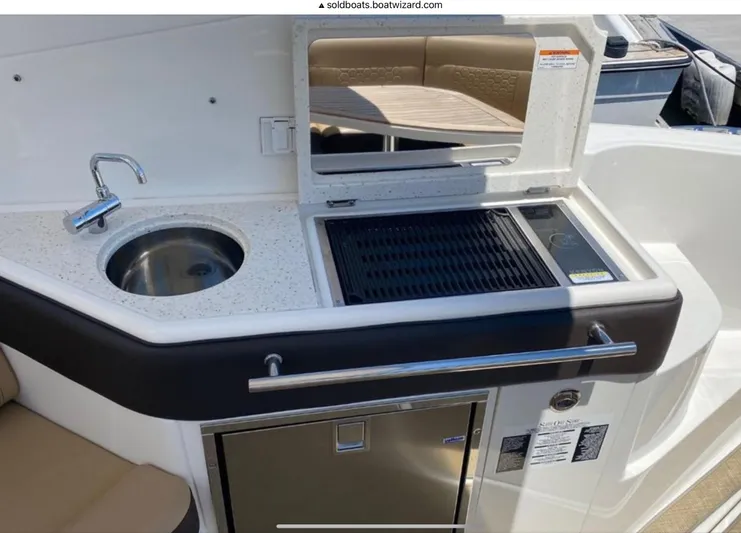 Hanamahina Yacht Photos Pics 2019 Sea Ray Sundancer 320 boat kitchenette with sink, grill, and storage.
