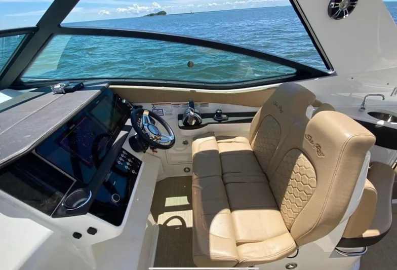 Hanamahina Yacht Photos Pics 2019 Sea Ray Sundancer 320 cockpit with beige leather seats, overlooking ocean view.