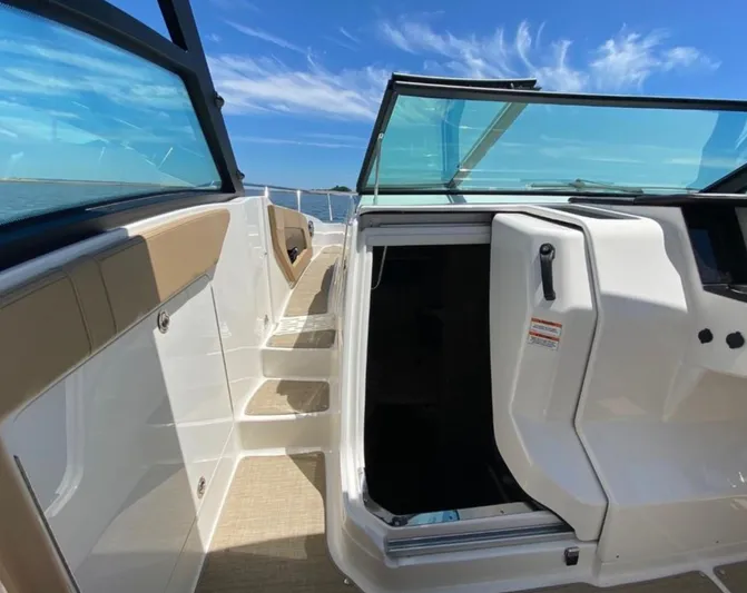 Hanamahina Yacht Photos Pics 2019 Sea Ray Sundancer 320 boat interior with open cabin door and clear blue sky.