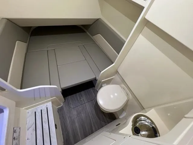  Yacht Photos Pics 2024 Scout 330 LXF cabin interior with seating, toilet, and sink.