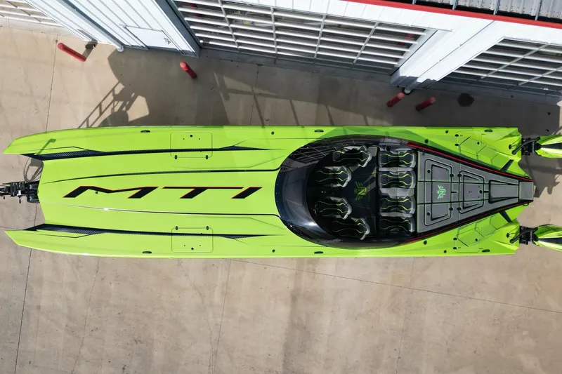  Yacht Photos Pics Aerial view of a vibrant green 2025 MTI 440X powerboat docked.