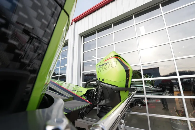  Yacht Photos Pics Green MTI 440X boat with Racing 300 engine, 2025 model, outside a glass-paneled building.