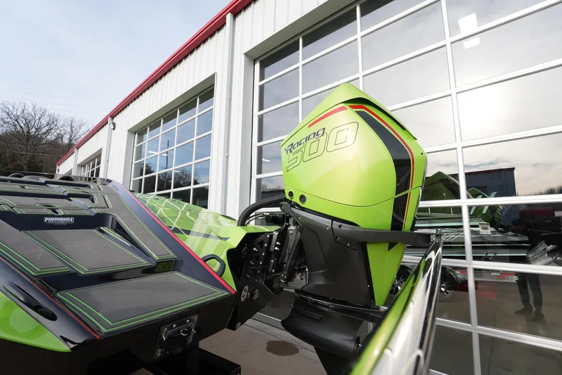  Yacht Photos Pics 2025 MTI 440X boat with green Racing 300 engine, parked outside a garage.