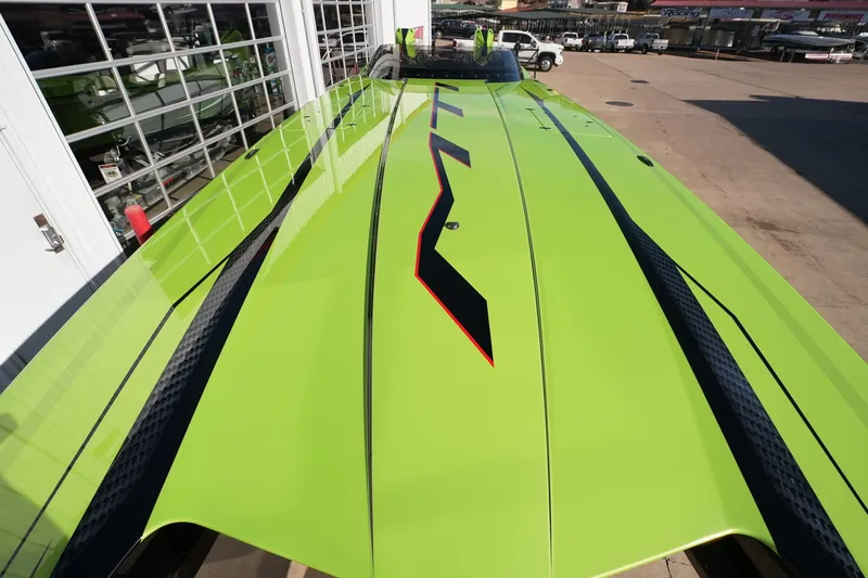  Yacht Photos Pics 2025 MTI 440X powerboat with vibrant green and black design, parked outdoors.