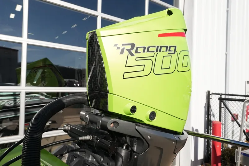  Yacht Photos Pics Bright green MTI 440X Racing 500 outboard motor, 2025 model, against a garage backdrop.