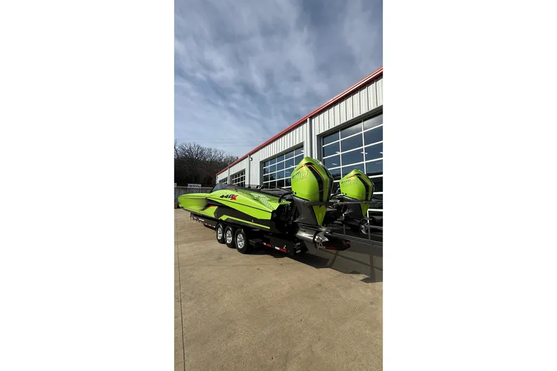  Yacht Photos Pics Bright green 2025 MTI 440X powerboat with dual engines on a trailer.