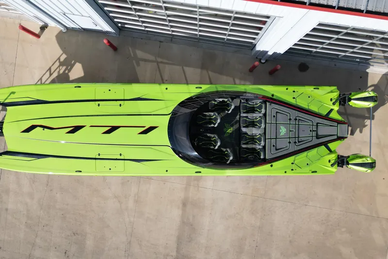  Yacht Photos Pics Aerial view of a vibrant green 2025 MTI 440X speedboat docked.
