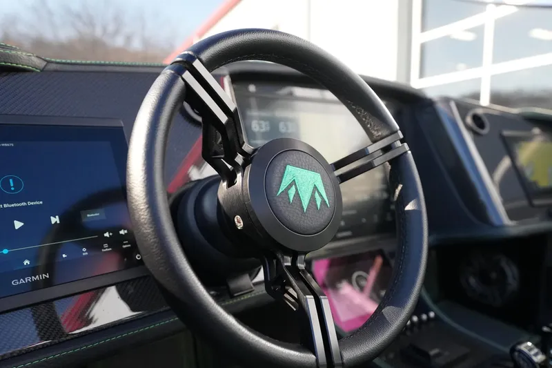  Yacht Photos Pics Steering wheel of 2025 MTI 440X boat with digital displays and Garmin system.