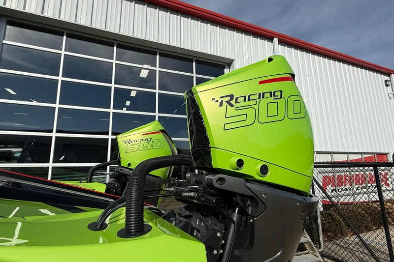  Yacht Photos Pics Bright green MTI 440X Racing 500 outboard motors, 2025 model, against industrial building backdrop.