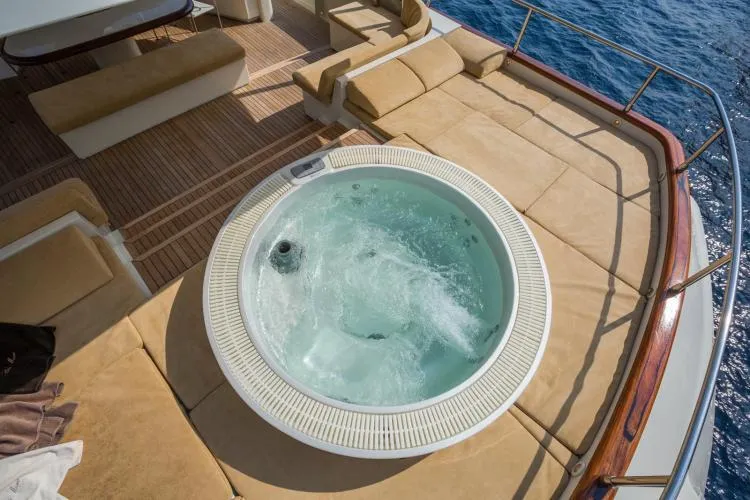  Yacht Photos Pics Luxurious Alalunga Navetta 30 yacht deck with jacuzzi, 1999 model, overlooking the ocean.