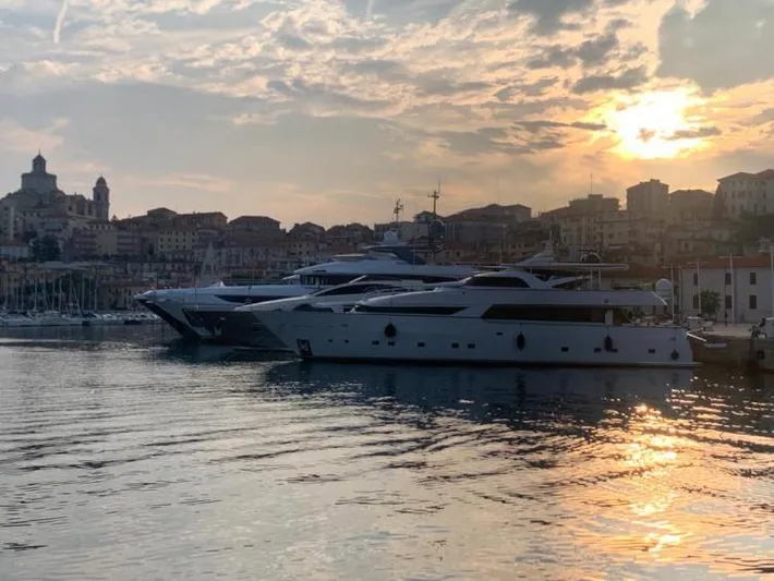  Yacht Photos Pics Luxury yachts docked at sunset, featuring a 1999 Alalunga Navetta 30.