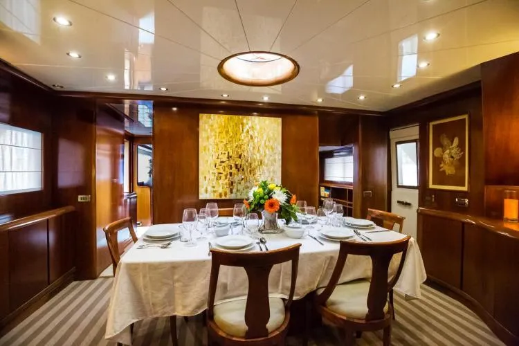  Yacht Photos Pics Luxurious dining area on 1999 Alalunga Navetta 30 yacht, featuring elegant decor and table setting.