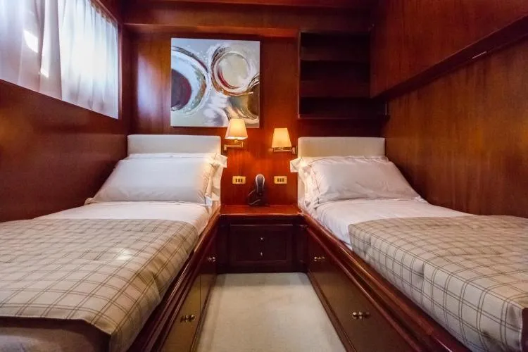  Yacht Photos Pics Luxurious twin cabin on 1999 Alalunga Navetta 30 yacht, featuring elegant wood paneling.