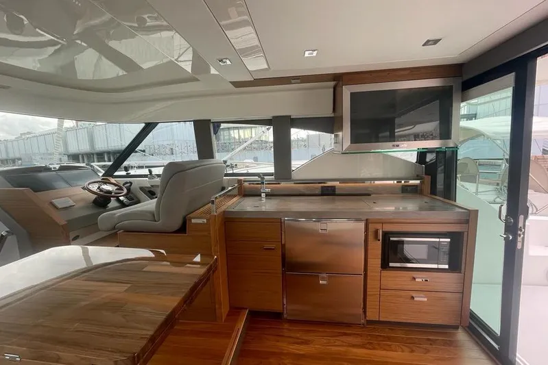 Enjoy Yacht Photos Pics Luxurious interior of 2023 Tiara Yachts C44 Coupe with modern kitchen and helm.