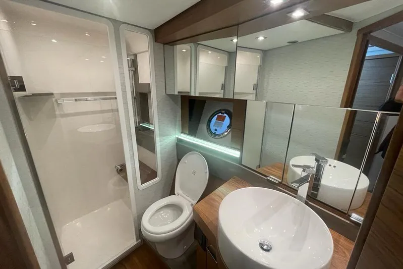 Enjoy Yacht Photos Pics Luxurious bathroom in 2023 Tiara Yachts C44 Coupe with modern fixtures and elegant design.