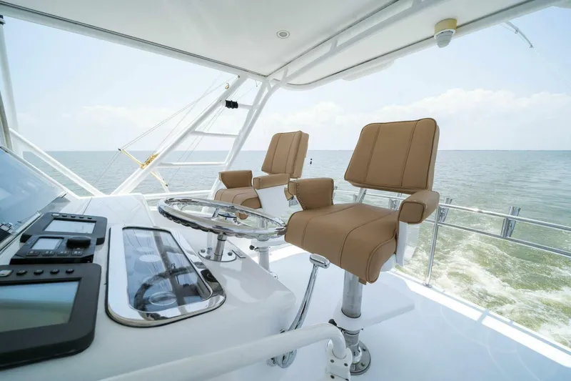 Big Boyd Yacht Photos Pics Helm station of 2003 Hatteras 54 Convertible yacht with ocean view.