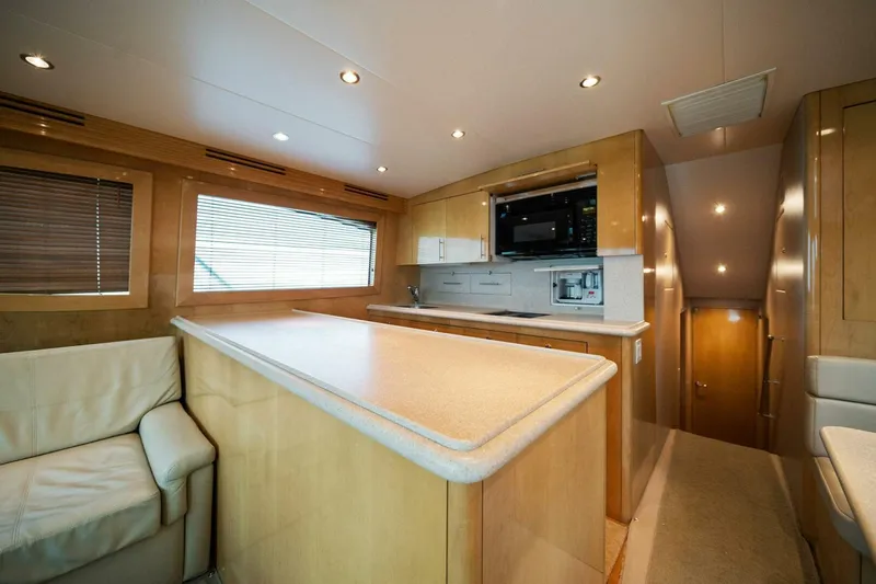 Big Boyd Yacht Photos Pics Interior of 2003 Hatteras 54 Convertible yacht with modern kitchen and seating area.