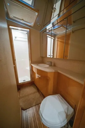 Big Boyd Yacht Photos Pics Bathroom interior of a 2003 Hatteras 54 Convertible yacht with shower, sink, and toilet.