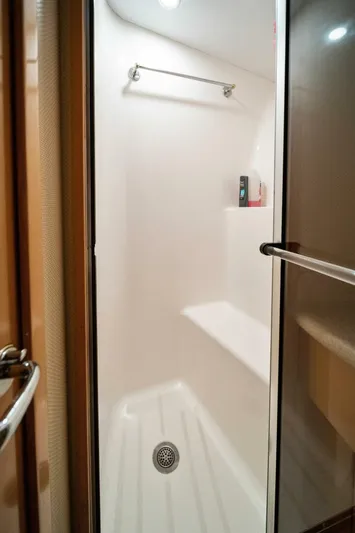 Big Boyd Yacht Photos Pics Shower stall in 2003 Hatteras 54 Convertible yacht with built-in seat and towel rack.