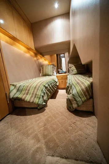 Big Boyd Yacht Photos Pics 2003 Hatteras 54 Convertible yacht interior with twin beds and striped bedding.