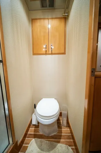 Big Boyd Yacht Photos Pics 2003 Hatteras 54 Convertible yacht bathroom with wooden cabinets and flooring.
