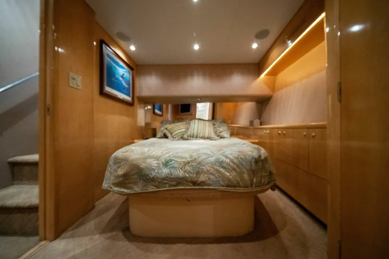 Big Boyd Yacht Photos Pics Luxurious bedroom interior of 2003 Hatteras 54 Convertible yacht with cozy bed and wooden cabinetry.