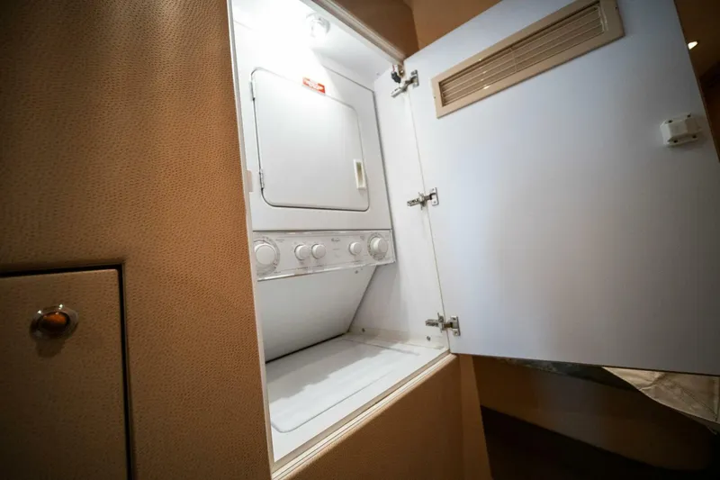 Big Boyd Yacht Photos Pics Laundry area inside 2003 Hatteras 54 Convertible yacht with washer and dryer.