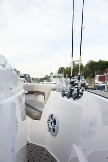  Yacht Photos Pics 2025 Solara S-310 CW boat with fishing rods and seating area.