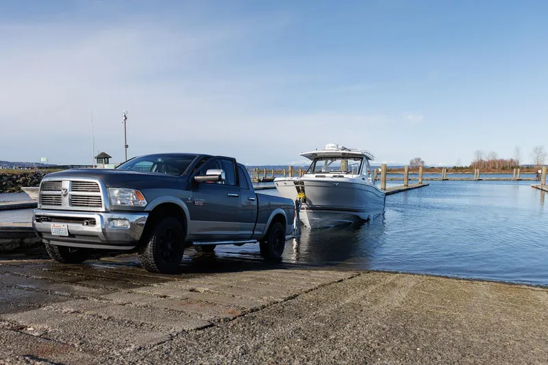  Yacht Photos Pics Truck launching Solara S-310 CW boat at a boat ramp, clear sky, 2025 model.