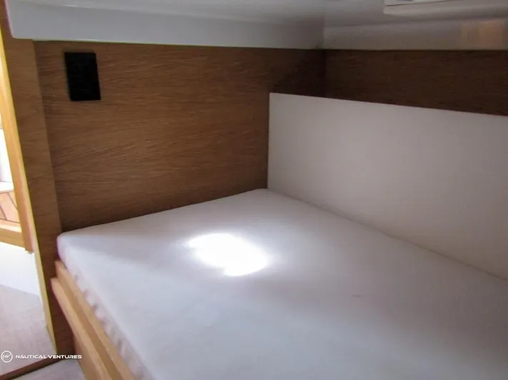 Yacht Photos Pics Interior cabin bed of 2022 De Antonio Yachts D34 Xplorer with wooden paneling.
