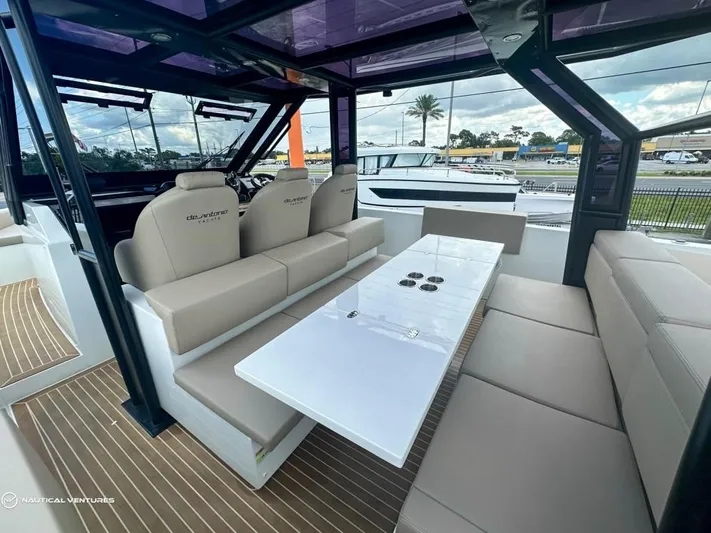  Yacht Photos Pics Interior of 2022 De Antonio Yachts D34 Xplorer with beige seating and white table.