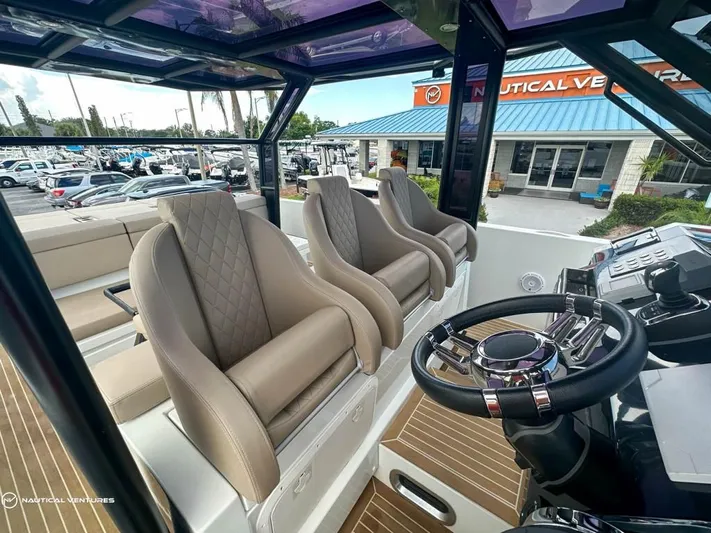  Yacht Photos Pics Interior of 2022 De Antonio Yachts D34 Xplorer with luxurious seating and modern helm.