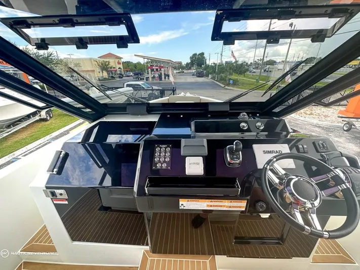 Yacht Photos Pics 2022 De Antonio Yachts D34 Xplorer helm station with modern controls and navigation equipment.