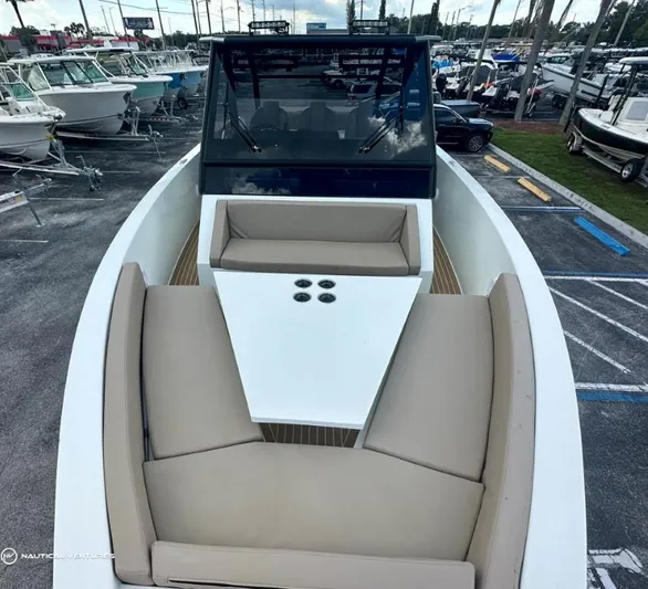  Yacht Photos Pics 2022 De Antonio Yachts D34 Xplorer with beige seating and white table, docked at marina.