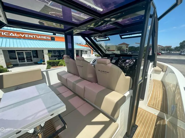  Yacht Photos Pics Interior of 2022 De Antonio Yachts D34 Xplorer with beige seating and modern helm.