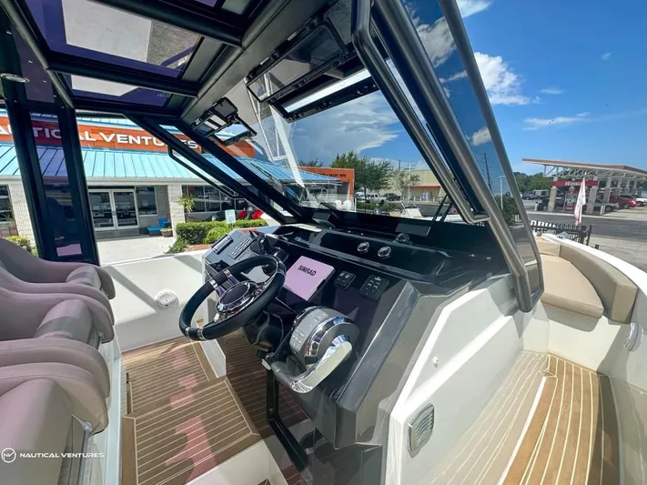  Yacht Photos Pics 2022 De Antonio Yachts D34 Xplorer cockpit with modern controls and navigation system.