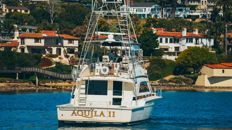 Aquila II Yacht Photos Pics 1990 Bertram 50 Convertible yacht "AQUILA II" cruising near coastal homes.