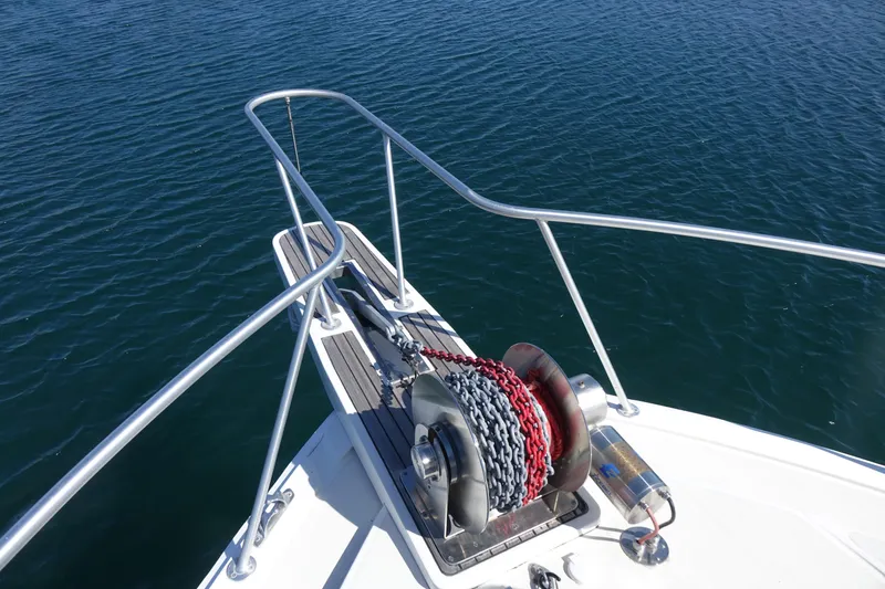 Aquila II Yacht Photos Pics Bow of 1990 Bertram 50 Convertible yacht with anchor chain and winch.