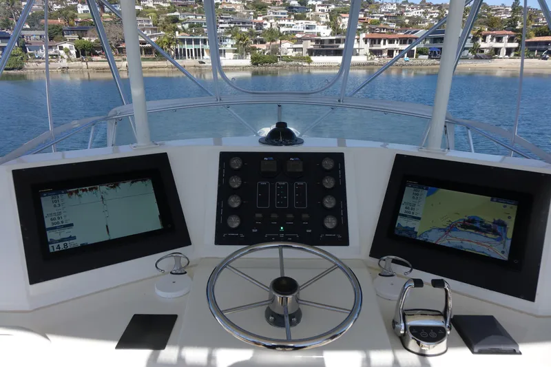 Aquila II Yacht Photos Pics Helm of 1990 Bertram 50 Convertible yacht with navigation screens and controls.