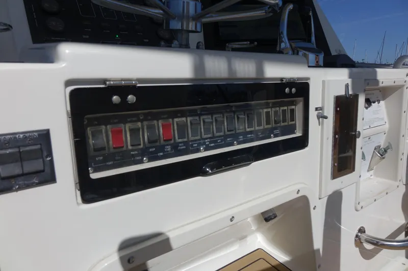 Aquila II Yacht Photos Pics Control panel of a 1990 Bertram 50 Convertible yacht with switches and dials.